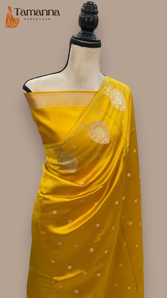 Yellow silk saree with gold zari border and scattered circular motifs on pallu