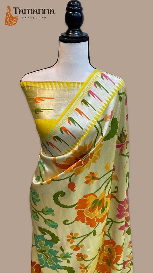 Banarasi saree draped on mannequin, yellow body with floral print and contrast border