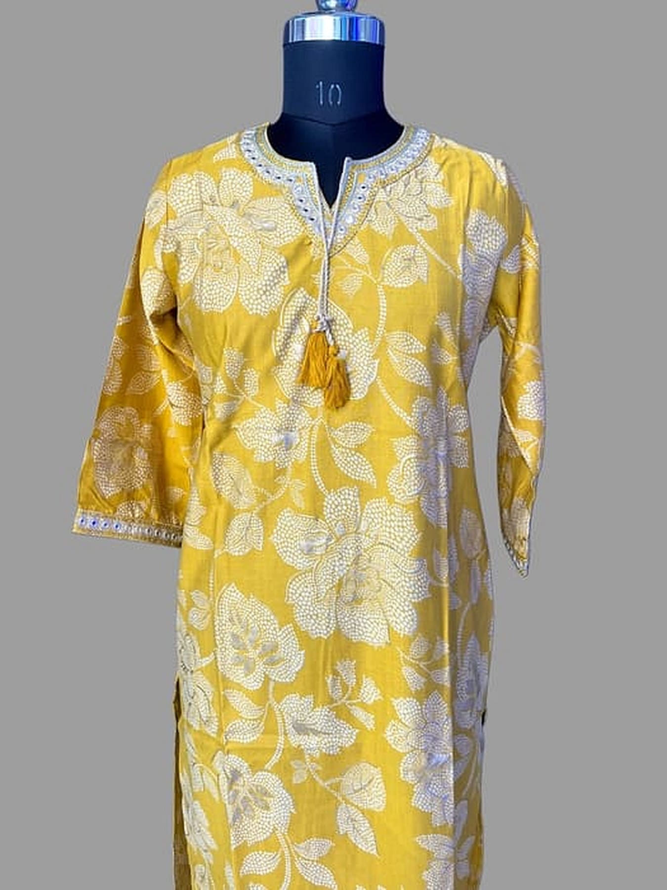 Yellow printed rayon kurta with contrast neckline and side tassel