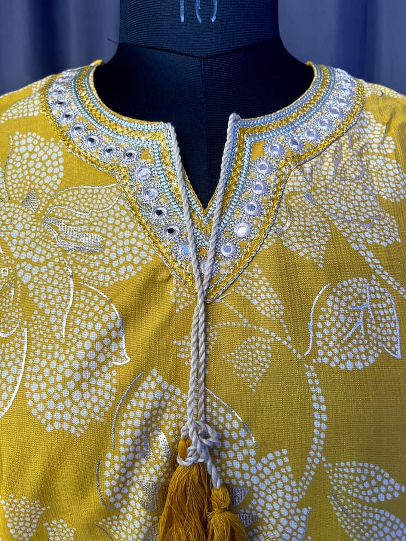 Yellow printed kurta yoke with beadwork border and tassel tie