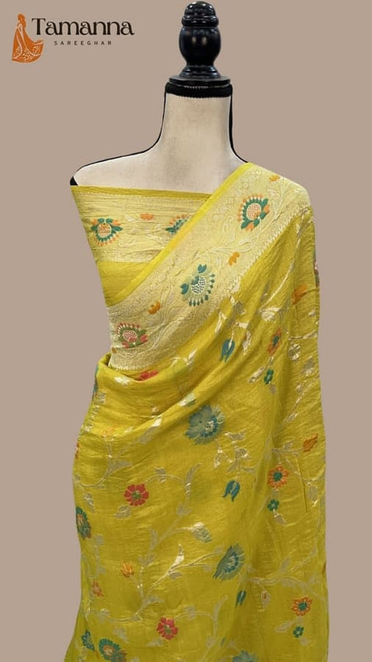 Yellow saree with contrasting pallu border and scattered floral motifs in green and pink