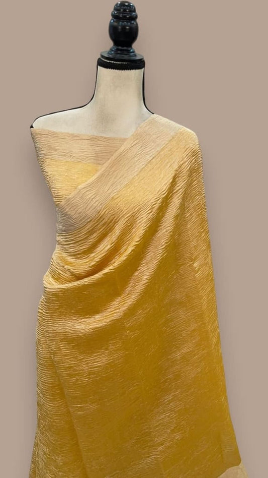 Yellow tissue crush handloom saree with draped pallu on mannequin